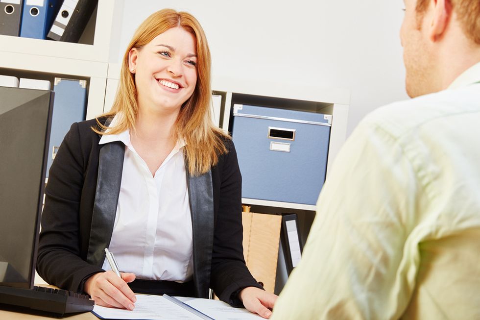 A human resources employee discusses salary with a job seeker.