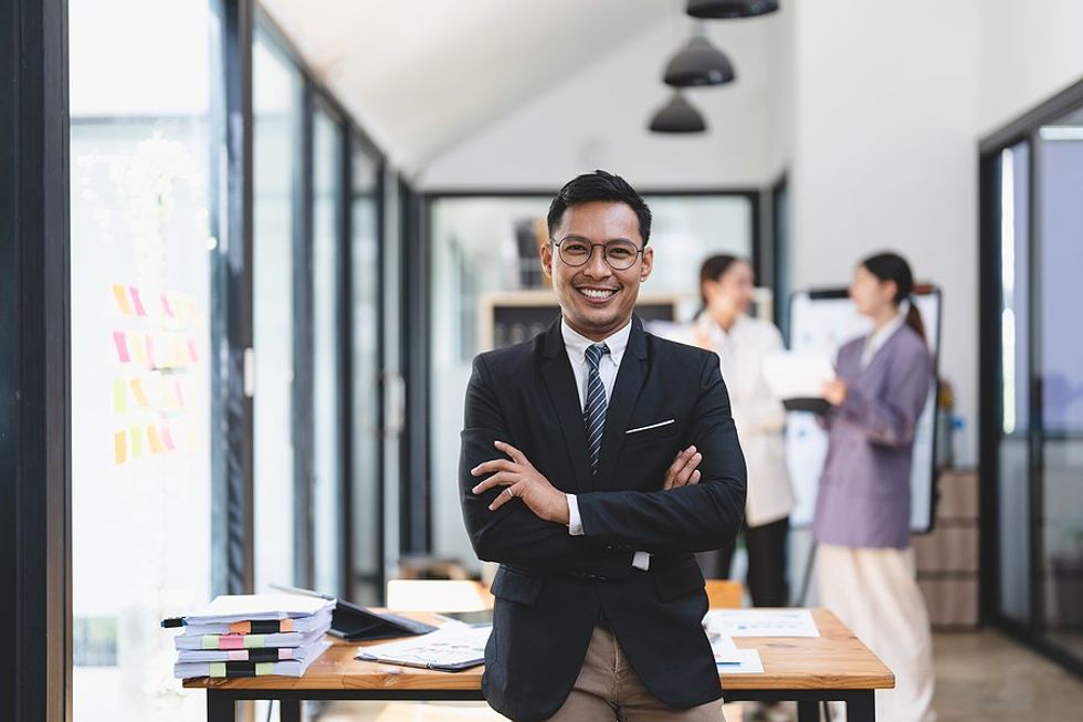 Executive / leader with a good LinkedIn executive presence smiles at work