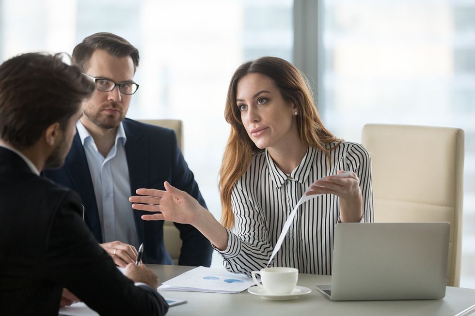 Female leader tackles conflicts and condescension at work during a meeting