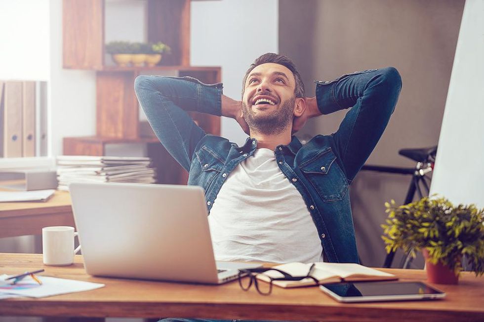 Happy man feels inspired while working