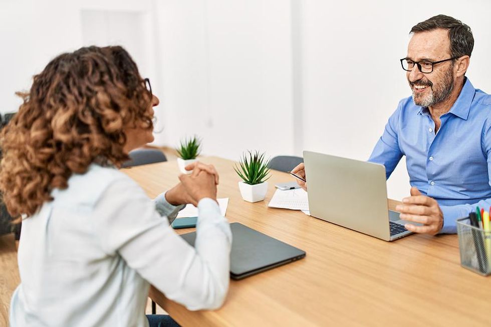 Happy man smiles at his coworker