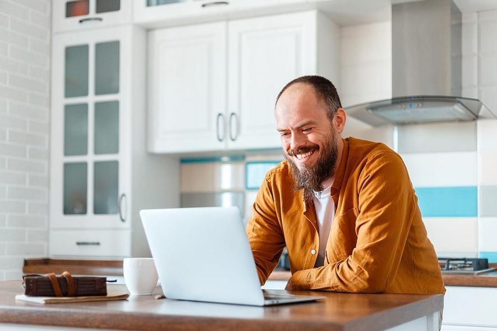 Happy older man on laptop looking for a job