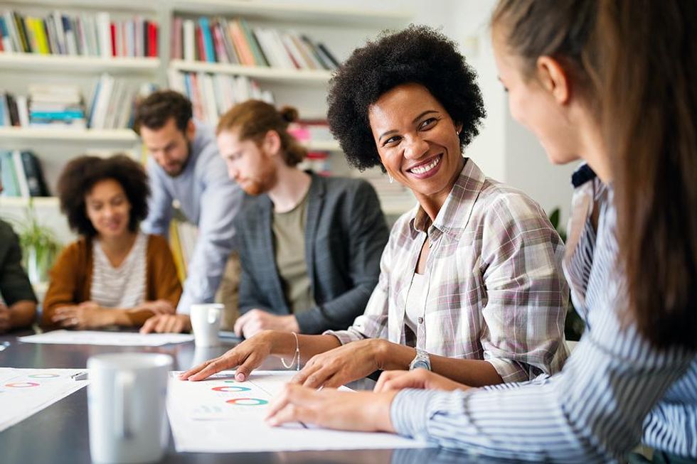 Happy woman smiles at her coworker