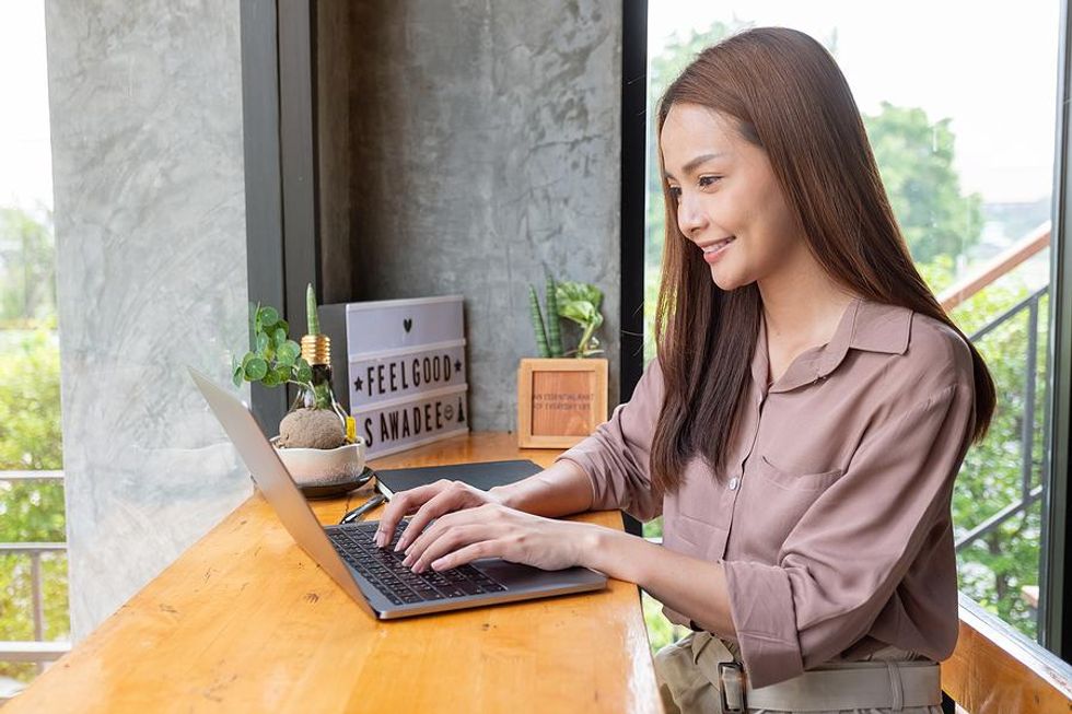 Happy woman working on her laptop