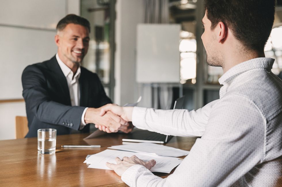 Job candidate shakes the hiring manager's hand before a job interview