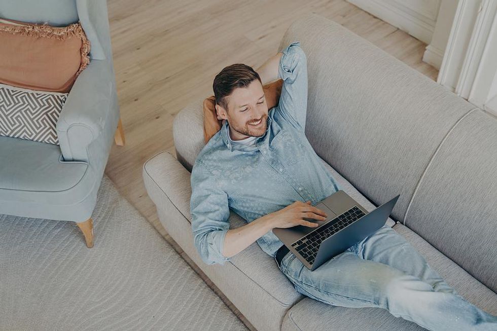 Man on laptop adds bullet points to his resume