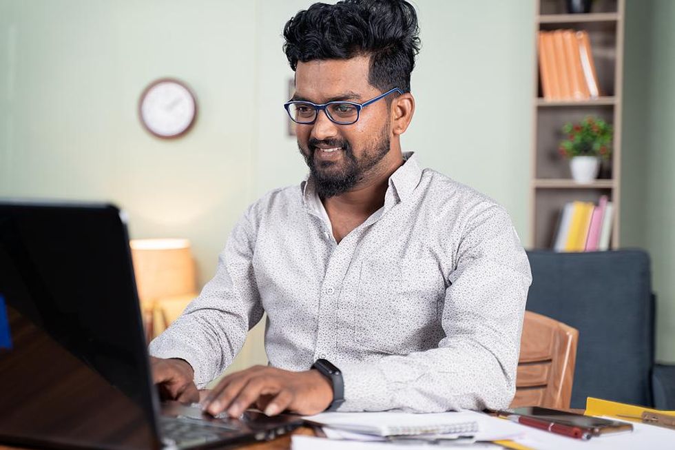 Man on laptop expands his knowledge and skills at work