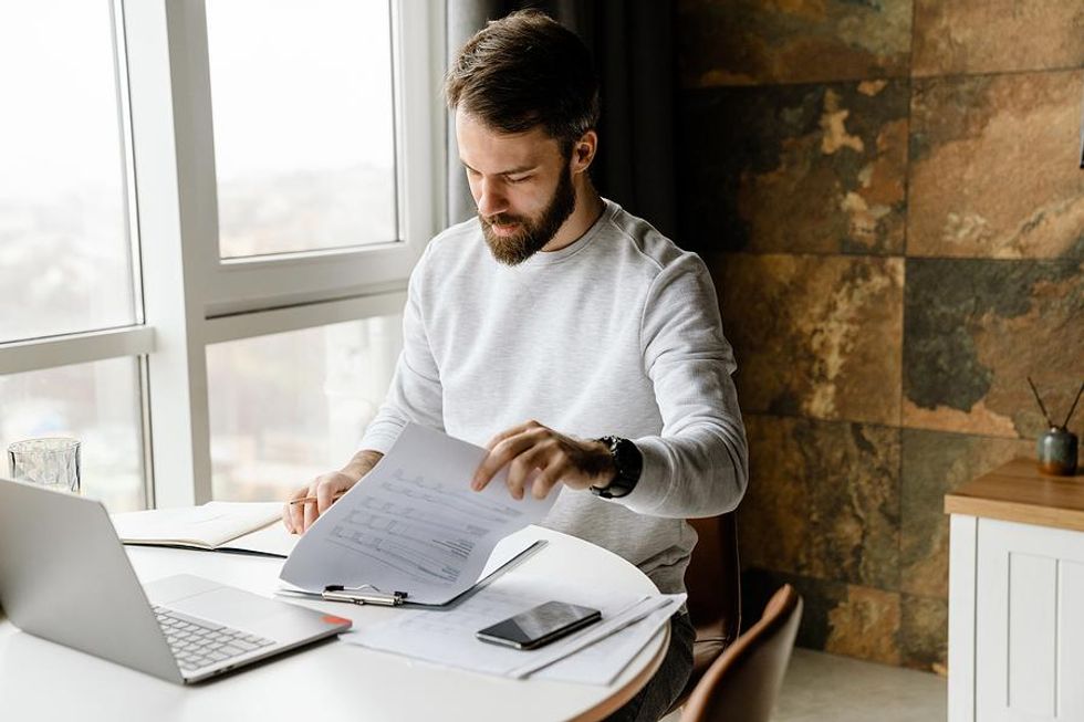 Man on laptop looks at bullet points on his resume