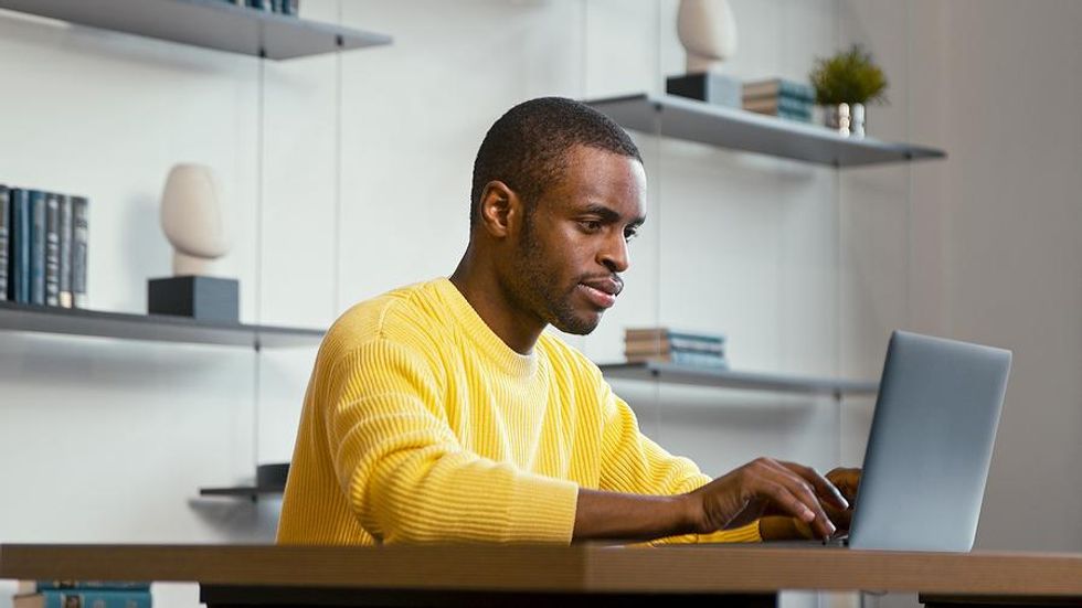 Man on laptop looks for a job