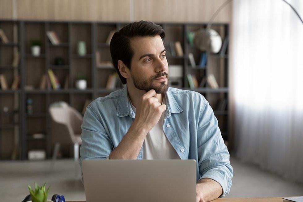 Man on laptop reflects on his career in the new year