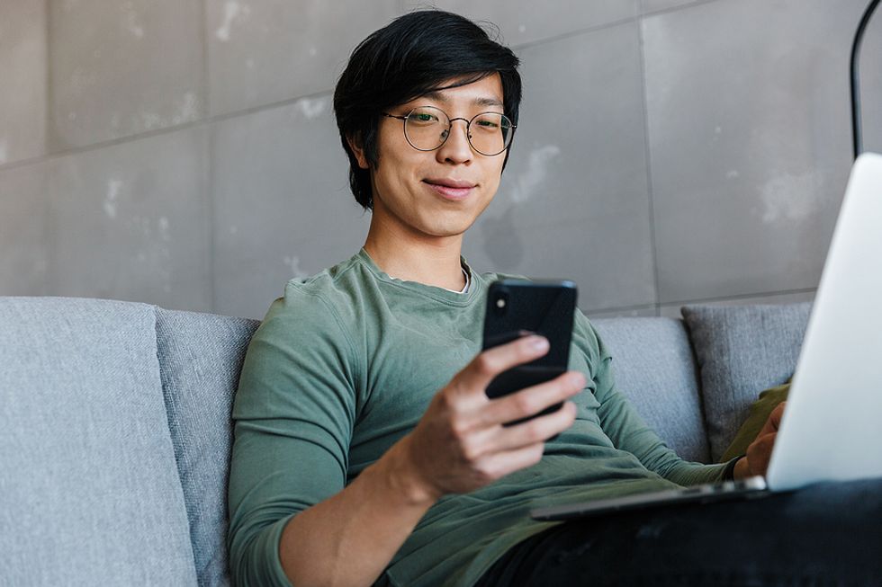 Man on phone and laptop masters backchanneling in his job search