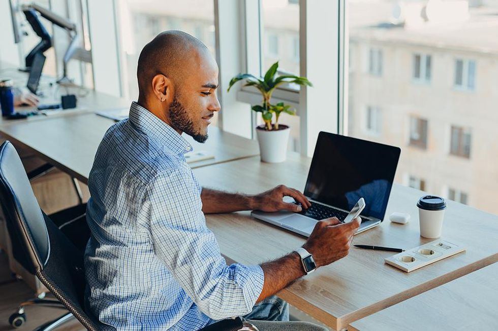 Man on phone applies for a job online