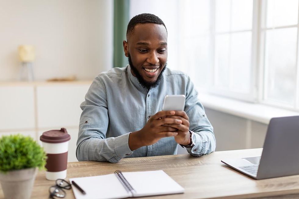 Man on phone lands an interview after using the law of attraction in his job search