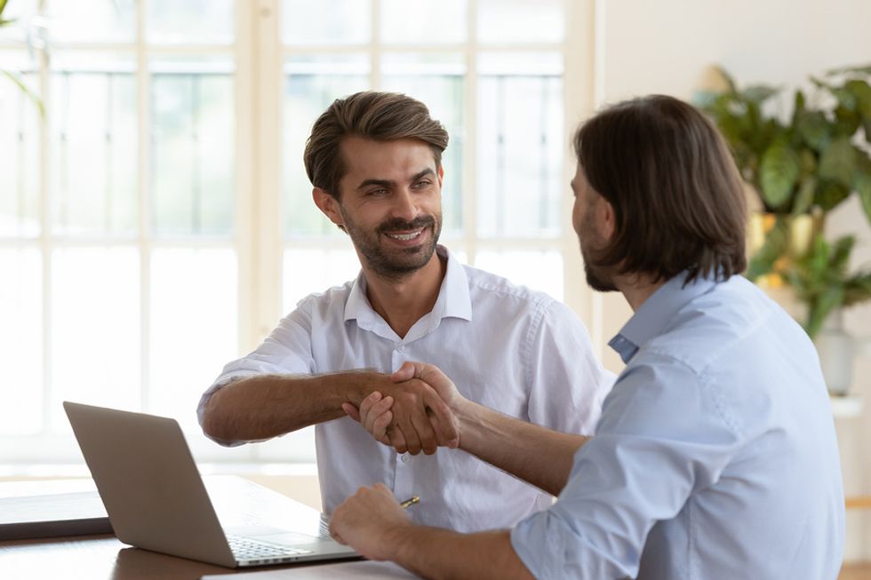 Man shakes hands with his career coach