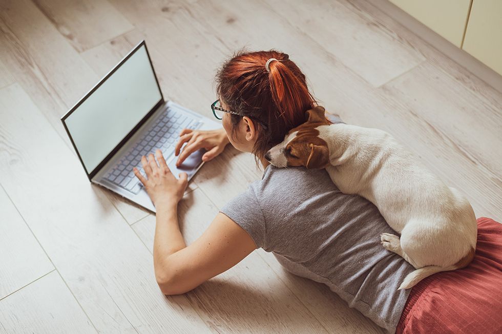 Unemployed woman on laptop writes her LinkedIn summary (About section)