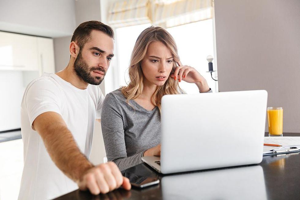 Woman and man looking at laptop avoid a job search scam