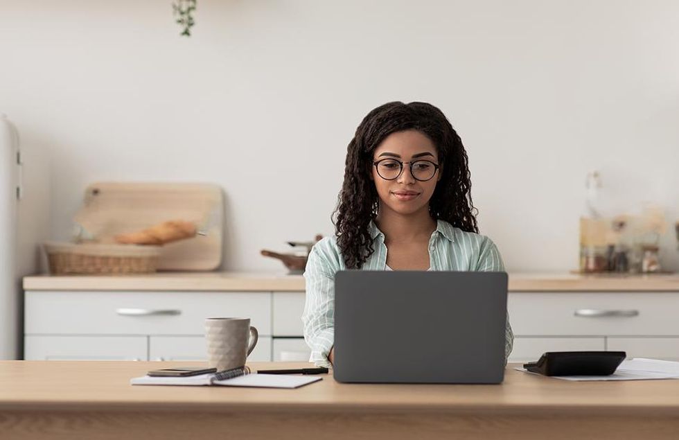 Woman on laptop adds work experience to her resume