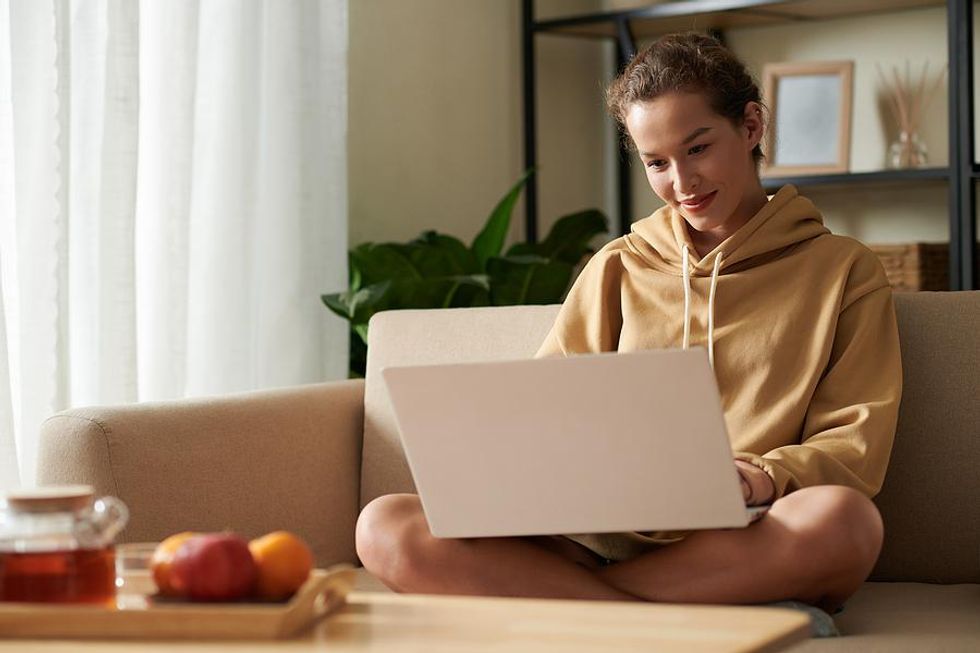 Woman on laptop emails an employer after realizing she's being ghosted