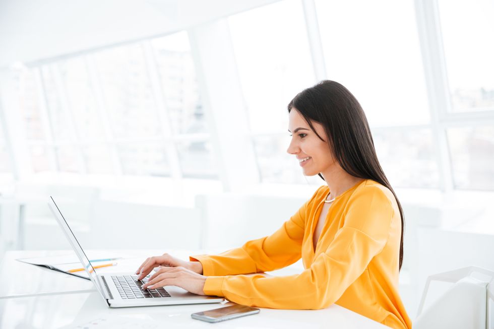 Woman on laptop explaining a job gap on resume