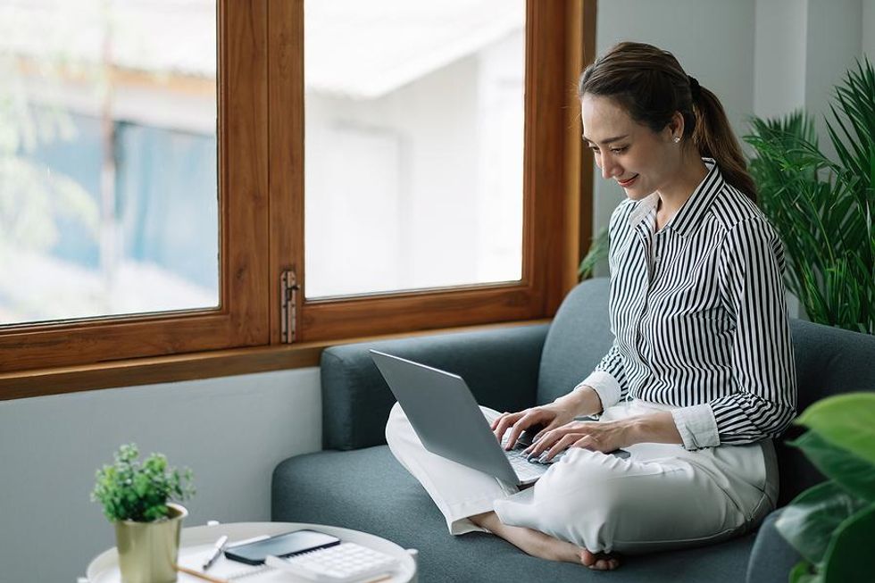 Woman on laptop updates her resume for a leadership role