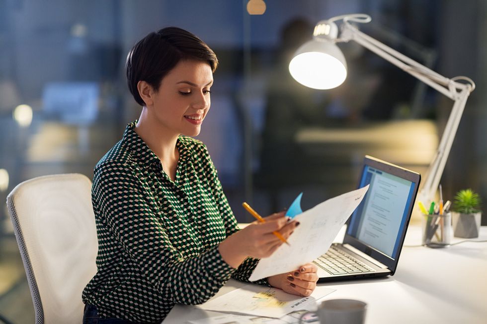 Woman reviewing her resume and tailoring it for a leadership role