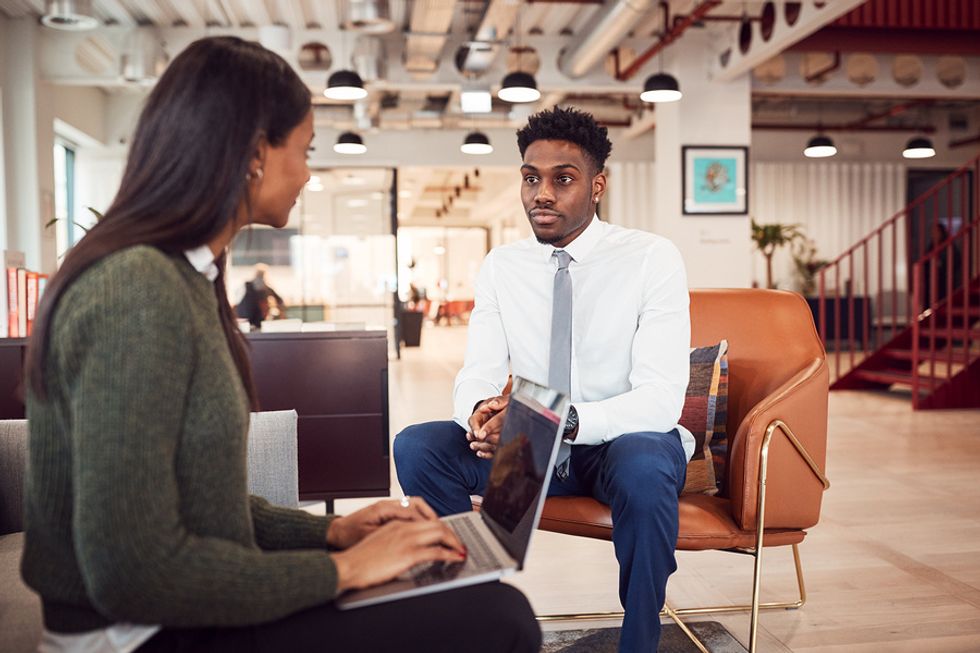 Young professional man being interviewed in a modern office